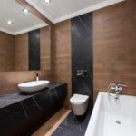 Modern bathroom with wooden accents, sleek fixtures, and minimalist design.